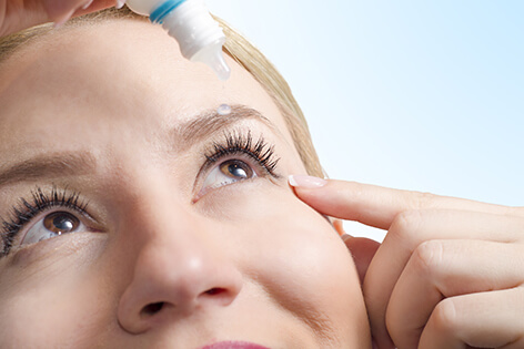 Woman Putting in Eye Drops