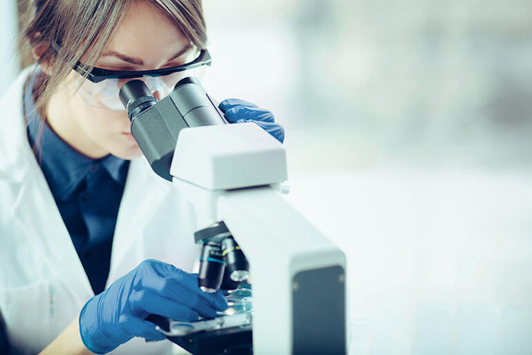 Woman Looking Through a Microscope