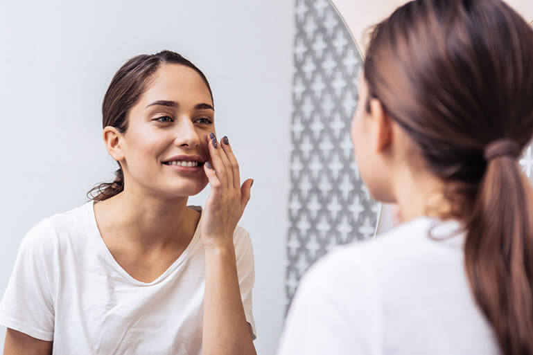 Woman Applying Skincare Product