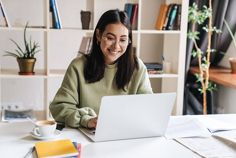 Happy Woman on Her Laptop Computer